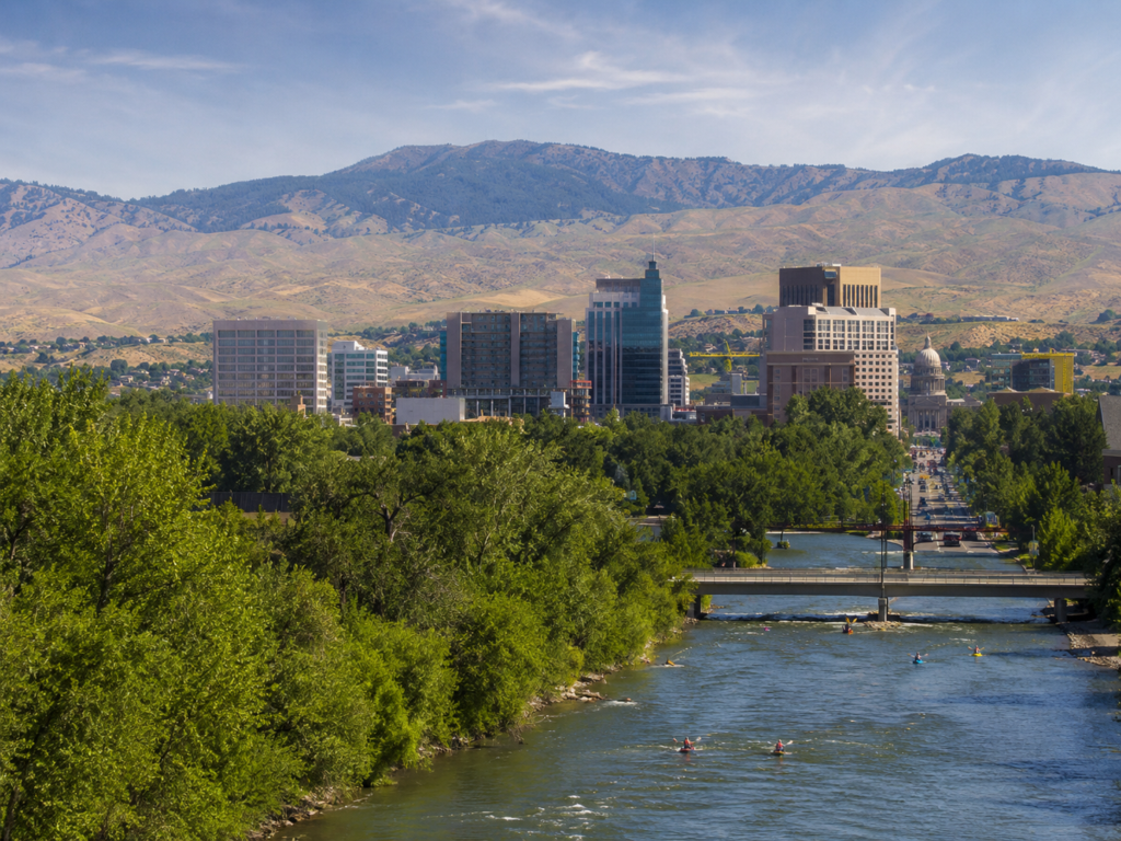 River running through central Boise with canoers and a bridge crossing the river.