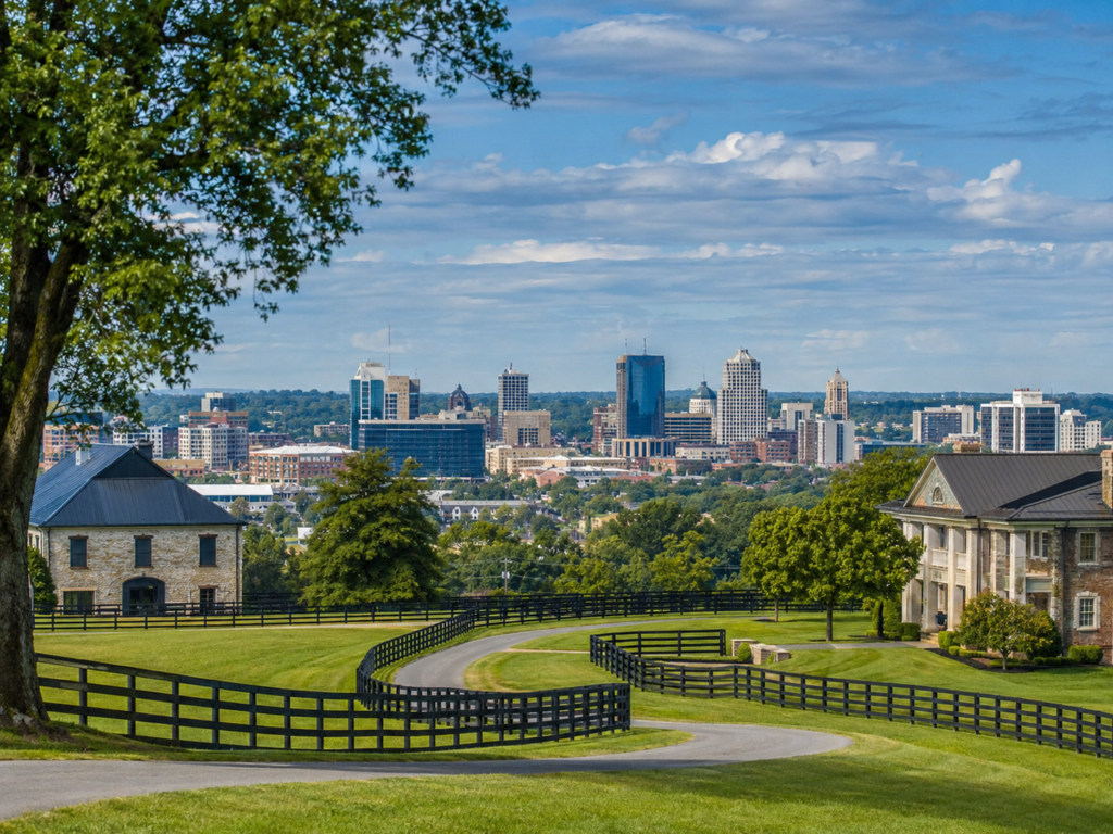 Beautiful mansion with freshly mowed lawn situated on a hill above the Lexington downtown area