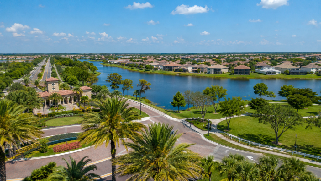 Osceola County master-planned suburban community with lakefront homes, palm trees, and residential streets.