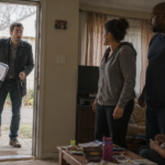 Real estate investor opening the door to a foreclosure home he just purchased and surprised to see that there are tenants inside the home.