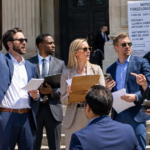 A group of real estate investors on the court house steps bidding on foreclosure properties on a bright sunny day.