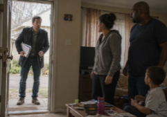 Real estate investor opening the door to a foreclosure home he just purchased and surprised to see that there are tenants inside the home.